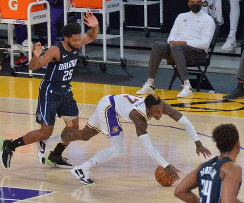 Los Angeles Lakers guard Dennis Schroder falls to the floor on the foul by Orlando Magic guard Chasson Randle during the first half at Staples Center in Los Angeles on Sunday, March 28, 2021. The Lakers defeated the Magic 96-93.  LAP2021032818 JIMxRUYMEN