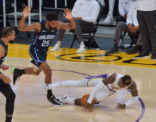 Los Angeles Lakers guard Dennis Schroder falls to the floor on the foul by Orlando Magic guard Chasson Randle during the first half at Staples Center in Los Angeles on Sunday, March 28, 2021. The Lakers defeated the Magic 96-93.  LAP2021032819 JIMxRUYMEN