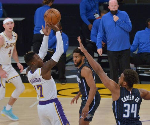 Los Angeles Lakers guard Dennis Schroder shoots over Orlando Magic guard Wendell Carter Jr. during the first half at Staples Center in Los Angeles on Sunday, March 28, 2021. The Lakers defeated the Magic 96-93.  LAP2021032820 JIMxRUYMEN