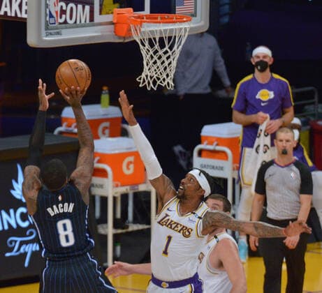 Orlando Magic forward Dwayne Bacon scores over Los Angeles Lakers guard Kentavious Caldwell-Pope during the first half at Staples Center in Los Angeles on Sunday, March 28, 2021. The Lakers defeated the Magic 96-93.  LAP2021032824 JIMxRUYMEN