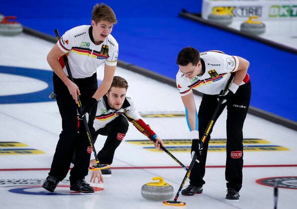 April 3, 2021, Calgary, ab, Canada: Germany skip Sixten Totzek, centre, makes a shot as lead Dominik Greindl, right, and second Joshua Sutor sweep while they play Switzerland at the Men s World Curling Championships in Calgary, Alta., Saturday, April 3, 2021. Dominik Greindl, Joshua Sutor, Sixten Totzek  - ZUMAc35_ 20210403_zaf_c35_026 Copyright: xJeffxMcintoshx