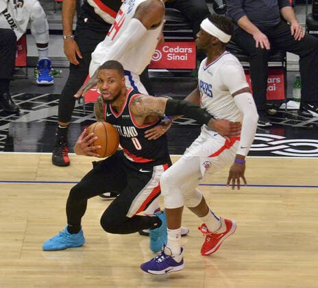 Portland Trail Blazers guard Damian Lillard commits an offensive foul on Los Angeles Clippers guard Reggie Jackson during the second half at Staples Center in Los Angeles on Tuesday, April 6, 2021. The Clippers blew out the Trail Blazers 133-116.  LAP2021040624 JIMxRUYMEN