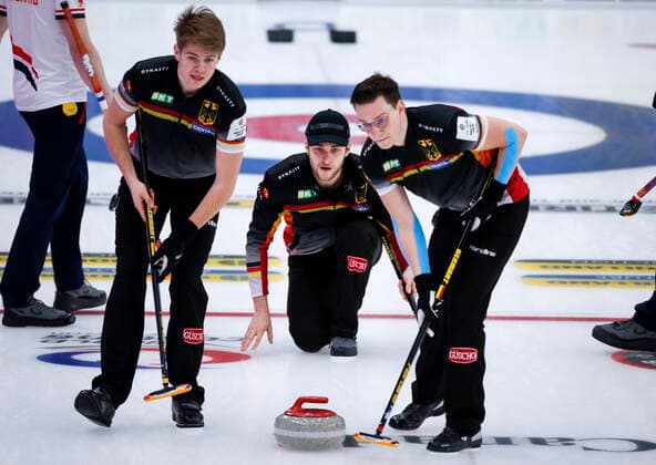 April 7, 2021, Calgary, ab, Canada: Germany skip Sixten Totzek, centre, makes a shot as lead Dominik Greindl, right, and second Joshua Sutor sweep against Netherlands at the Men s World Curling Championships in Calgary, Alta., Wednesday, April 7, 2021. Sixten Totzek, Dominik Greindl, Joshua Sutor  - ZUMAc35_ 20210407_zaf_c35_013 Copyright: xJeffxMcintoshx