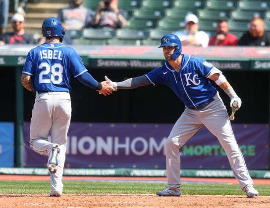 Kansas City Royals Kyle Isbel (28) is greeted by Whit Merrifield (15) after scoring in the seventh inning against the Cleveland Indians at Progressive Field in Cleveland, Ohio on Wednesday, April 7, 2021.  CLE20210407112 AARONxJOSEFCZYK