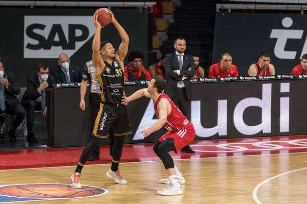 Basketball, BBL, 20210411, FC Bayern München Basketball Löwen Braunschweig Pictured Karim JALLOW Basketball Löwen Braunschweig, 35 and Paul ZIPSER FC Bayern München, 16 Munich Audi Dome Bayern Germany Copyright: Passion2Press MarkusxFischerx