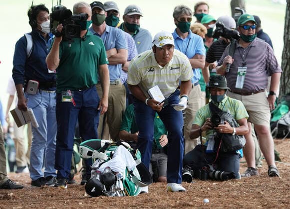 Hideki Matsuyama of Japan lines up a shot from the pine straw on the 1st hole in the final round of the 2021 Masters Tournament at the Augusta National Golf Club in Augusta, Georgia on Sunday, April 11, 2021.  AUG20210411303 KEVINxDIETSCH