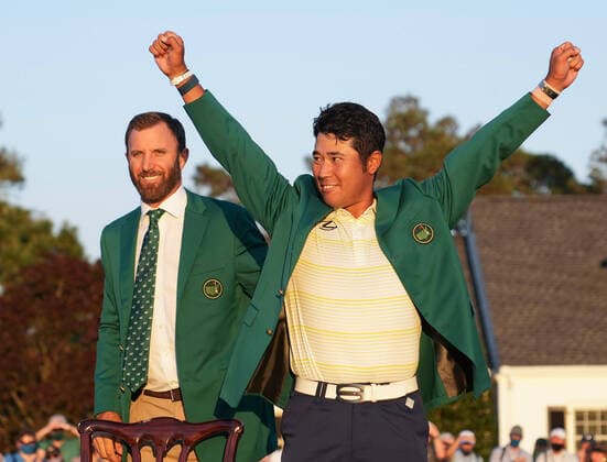 Masters champion Hideki Matsuyama of Japan reacts after Dustin Johnson puts the Green Jacket on him after the final round of the 2021 Masters Tournament at the Augusta National Golf Club in Augusta, Georgia on Sunday, April 11, 2021. Matsuyama wins his first major with a score of 10 under par.  AUG20210411478 KEVINxDIETSCH