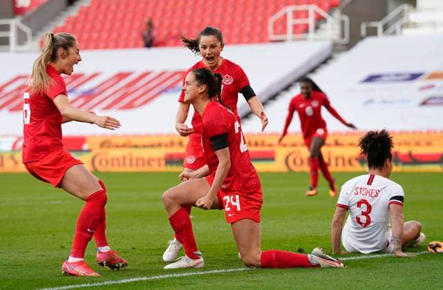 Stoke, England, 13th April 2021. Evelyne Viens of Canada celebrates scoring the first goal during the International Football Friendly match at The Bet365 Stadium, Stoke. Picture credit should read: Andrew Yates Sportimage EDITORIAL USE ONLY. No use with unauthorised audio, video, data, fixture lists, club league logos or live services. Online in-match use limited to 120 images, no video emulation. No use in betting, games or single club league player publications. SPI-0999-0003