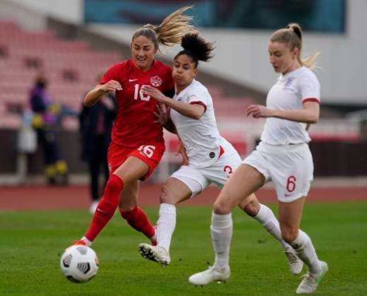 Stoke, England, 13th April 2021. Demi Stokes of England tackles Janine Beckie of Canada during the International Football Friendly match at The Bet365 Stadium, Stoke. Picture credit should read: Andrew Yates Sportimage EDITORIAL USE ONLY. No use with unauthorised audio, video, data, fixture lists, club league logos or live services. Online in-match use limited to 120 images, no video emulation. No use in betting, games or single club league player publications. SPI-0999-0012