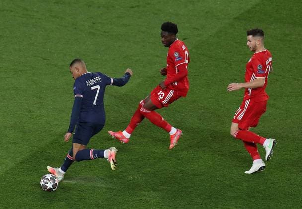 (210414) -- PARIS, April 14, 2021 -- Kylian Mbappe (L) of Paris Saint-Germain vies with Alphonso Davies (C) of Bayern Munich during the UEFA Champions League quarterfinal second leg football match between Paris Saint-Germain and Bayern Munich at the Parc des Princes stadium in Paris, France on April 13, 2021. ) (SP)FRANCE-PARIS-FOOTBALL-UEFA CHAMPIONS LEAGUE-PSG VS BAYERN MUNICH GaoxJing 