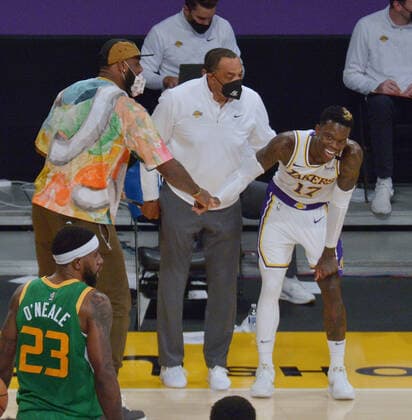 Los Angeles Lakers point guard Dennis Schroder is all smiles as his injured teammate LeBron James praises him for sending the game against the Utah Jazz to overtime at Staples Center in Los Angeles on Saturday, April 17, 2021. The Lakers won with a 127-115 overtime defeat of the first-place Jazz.  LAP2021041710 JIMxRUYMEN