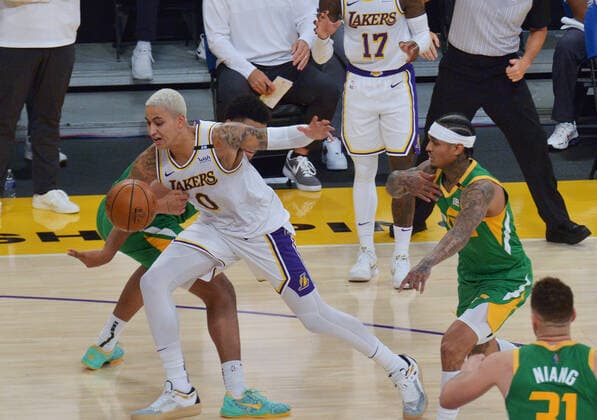 Los Angeles Lakers guard Kyle Kuzma loses the ball as he is fouled by a Utah Jazz defender during the second half at Staples Center in Los Angeles on Saturday, April 17, 2021. The Lakers won with a 127-115 overtime defeat of the first-place Jazz.  LAP2021041721 JIMxRUYMEN