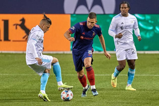 CHICAGO, IL - APRIL 17: New England Revolution forward Gustavo Bou (7) battles with Chicago Fire midfielder Luka Stojanovic (8) in action during a match between the Chicago Fireand the New England Revolution on April 17, 2021 at Soldier Field in Chicago, IL. (Photo by Robin Alam Icon Sportswire) SOCCER: APR 17 MLS, Fussball Herren, USA - New England Revolution at Chicago Fire FC Icon16404172122