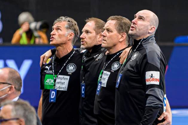 Stuttgart, Germany 02 Mail 2021 Mens EHF Euro 2022 Qualification, Germany vs Estonia v li Physio PeterGräschus Germany , Goalkeeping Coach MAttias Andersson Germany , Coach Alfred Gislason Germany , Co Coach Erik Wudtke Germany during the National Anthem Stuttgart Porsche Arena Baden Württemberg Germany