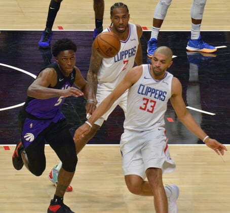 Toronto Raptors forward Stanley Johnson (5) chases the loose ball under pressure from Los Angeles Clippers forwards Kawhi Leonard (2) and Nicolas Batum (33) during the second half at Staples Center in Los Angeles on Tuesday, May 4, 2021. The Clippers defeated the Raptors 105-100 to end a three-game losing streak.  LAP2021050401 JIMxRUYMEN