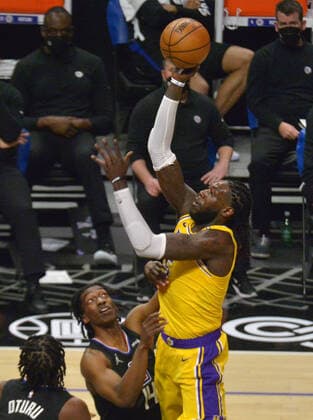 Los Angeles Lakers center Montrezl Harrell (15) is fouled by Los Angeles Clippers guard Terance Mann (14) during the second half at Staples Center in Los Angeles on Thursday May 6, 2021. The Clippers defeated the Lakers 118-94.  LAP2021050618 JIMxRUYMEN