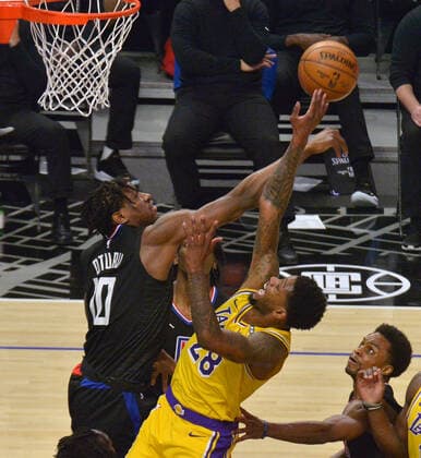 Los Angeles Lakers forward Alfonzo McKinnie (28) is fouled by Los Angeles Clippers center Daniel Oturu (10) during the second half at Staples Center in Los Angeles on Thursday May 6, 2021. The Clippers defeated the Lakers 118-94.  LAP2021050619 JIMxRUYMEN