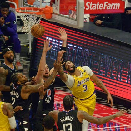 Los Angeles Lakers guard Anthony Davis (3) is unable to score as he is triple-teamed by Los Angeles Clippers forward Kawhi Leonard (2), center Ivica Zubac (40) and guard Paul George (13) during the first half at Staples Center in Los Angeles on Thursday May 6, 2021. The Clippers defeated the Lakers 118-94.  LAP2021050621 JIMxRUYMEN