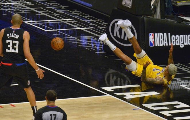 Los Angeles Lakers forward Kyle Kuzma (0) falls to the floor after being fouled by Los Angeles Clippers forward Nicolas Batum (33) during the first half at Staples Center in Los Angeles on Thursday May 6, 2021. The Clippers defeated the Lakers 118-94.  LAP2021050622 JIMxRUYMEN