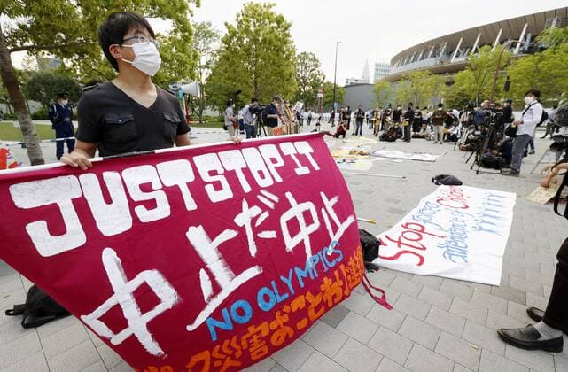 Protest against Tokyo Olympics People protest against holding the Tokyo Olympics amid the coronavirus pandemic, near National Stadium in Tokyo on May 9, 2021, as an Olympic test event for athletics is held inside the venue. 