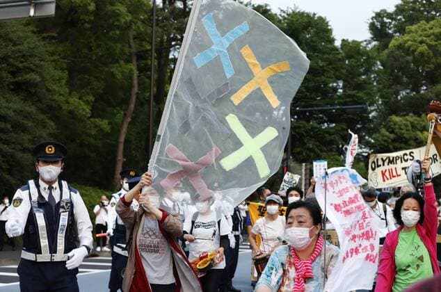 Protest against Tokyo Olympics People protest around National Stadium in Tokyo on May 9, 2021, against holding the Tokyo Olympics amid the coronavirus pandemic, as an Olympic test event for athletics is held inside the stadium. 