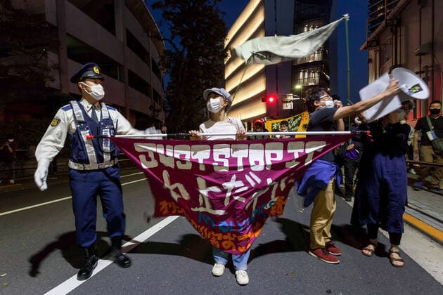 May 9, 2021, Tokyo, Japan: A protester wearing a mask holds a banner expressing his opinion during the demonstration..About 100 people took part in a demo outside the Japanese Olympic Committee museum and marched around the new Olympic Stadium to protest holding the event while the COVID-19 pandemic is still seriously affecting Japan. Tokyo Japan - ZUMAs197 0117354621st Copyright: xDamonxCoulterx