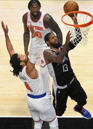 LOS ANGELES, CA - MAY 09: Paul George (13) of the LA Clippers gets past Derrick Rose (4) for a layup while Julius Randle (30) of the New York Knicks looks on in the second half during the Los Angeles Clippers versus New York Knicks at on May 9, 2021, at Staples Center in Los Angeles, CA. (Photo by John McCoy Icon Sportswire) NBA, Basketball Herren, USA MAY 09 Knicks at Clippers Icon2105090033
