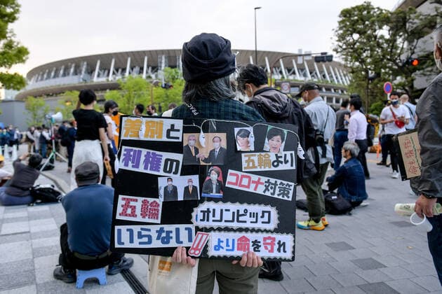 May 9, 2021, Tokyo, Japan: A protester holds a placard during demonstration against the Tokyo Olympics in front of the New National Stadium, the main stadium for the Tokyo Olympics..With less than 3 months remaining until the opening of the Tokyo 2020 Olympics concern continues to linger in Japan over the feasibility of hosting such a huge event during the ongoing COVID-19 pandemic. Tokyo Japan - ZUMAs197 0117369324st Copyright: xCezaryxKowalskix