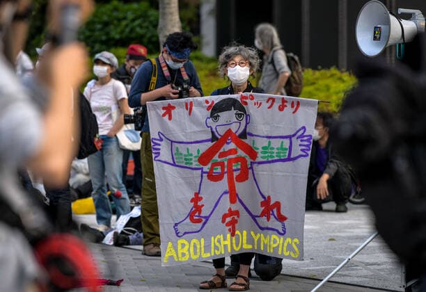 May 9, 2021, Tokyo, Japan: A protester holds a banner during a protest against the Tokyo Olympics in front of the New National Stadium, the main stadium for the Tokyo Olympics..With less than 3 months remaining until the opening of the Tokyo 2020 Olympics concern continues to linger in Japan over the feasibility of hosting such a huge event during the ongoing COVID-19 pandemic. Tokyo Japan - ZUMAs197 0117369346st Copyright: xCezaryxKowalskix