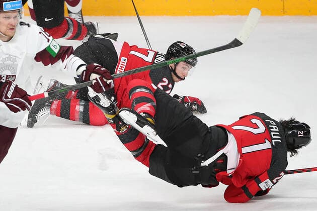 RIGA, LATVIA - MAY 21, 2021: Latviaâ€™s Rodrigo Abols, Canada s Michael Bunting and Nick Paul (L-R) in action in their 2021 IIHF World Championship, WM, Weltmeisterschaft Group A Ice hockey, Eishockey match at Arena Riga. Natalia Fedosenko TASS  TS100E32