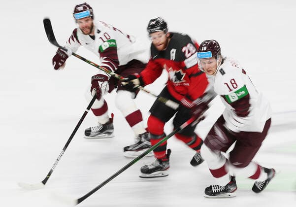 Eishockey, WM, Kanada - Lettland RIGA, LATVIA - MAY 21, 2021: Latvia s Lauris Darzins, Canada s Connor Brown, and Latviaâ€™s Rodrigo Abols (L-R) in action in their 2021 IIHF World Championship, WM, Weltmeisterschaft Group A Ice hockey, Eishockey match at Arena Riga. Natalia Fedosenko TASS  TS100E50