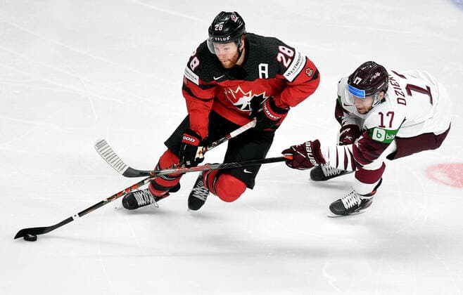 (210522) -- RIGA, May 22, 2021 -- Latvia s forward Martins Dzierkals (R) vies with Canada s forward Connor Brown during the Group B match between Latvia and Canada at the 2021 IIHF Ice hockey, Eishockey World Championship, WM, Weltmeisterschaft in Riga, Latvia, May 21, 2021. (Photo by Xinhua) (SP)LATVIA-RIGA-ICE HOCKEY-WORLD CHAMPIONSHIP-LATVIA VS CANADA EdijsxPalens 