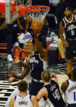 Los Angeles Clippers forward Kawhi Leonard (2) scores a reverse layup on Dallas Maverick s defenders during the first half of their best-of-seven playoff series opener at Staples Center in Los Angeles on Saturday, May 22, 2021. The Mavericks defeated the Clippers 113-103.  LAP2021052221 JIMxRUYMEN