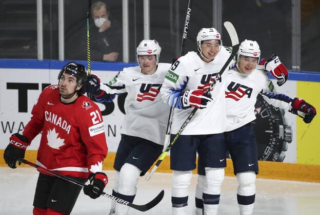 RIGA, LATVIA - MAY 23, 2021: The USA s Ryan Donato, Jason Robertson and Trevor Moore (L-R background) celebrate scoring in the 2021 IIHF World Championship, WM, Weltmeisterschaft Group B Ice hockey, Eishockey match against Canada at Arena Riga. Pictured: Canada s Nick Paul (front). Natalia Fedosenko TASS  TS101154