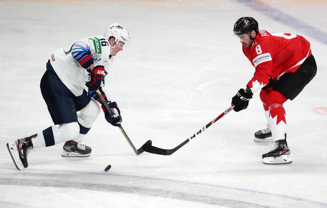 RIGA, LATVIA - MAY 23, 2021: The USA s Ryan Donato (L) and Canada s Liam Foudy fight for the puck in their 2021 IIHF World Championship, WM, Weltmeisterschaft Group B Ice hockey, Eishockey match at Arena Riga. Natalia Fedosenko TASS  TS10115D