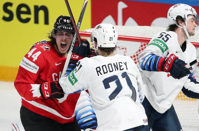 RIGA, LATVIA - MAY 23, 2021: Canada s Max Comtois and the USA s Kevin Rooney, Matthew Hellickson (L-R) in action in their 2021 IIHF World Championship, WM, Weltmeisterschaft Group B Ice hockey, Eishockey match at Arena Riga. Natalia Fedosenko TASS  TS101182