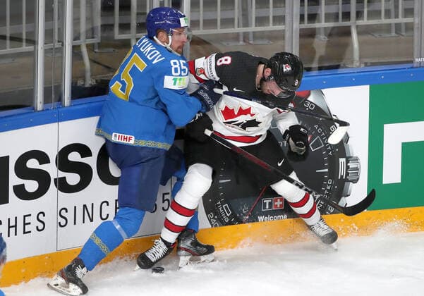 RIGA, LATVIA â€“ MAY 28, 2021: Kazakhstan s Alexei Maklyukov (L) and Canada s Liam Foudy fight for the puck in their 2021 IIHF Ice hockey, Eishockey World Championship, WM, Weltmeisterschaft Preliminary Round Group B match, at the Arena Riga. Natalia Fedosenko TASS  TS101DD7