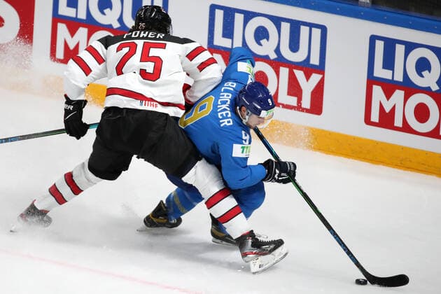 RIGA, LATVIA â€“ MAY 28, 2021: Canada s Owen Power (L) and Kazakhstan s Jesse Blacker fight for the puck in their 2021 IIHF Ice hockey, Eishockey World Championship, WM, Weltmeisterschaft Preliminary Round Group B match, at the Arena Riga. Natalia Fedosenko TASS  TS101DF6