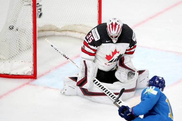 RIGA, LATVIA â€“ MAY 28, 2021: Kazakhstan s Nikita Mikhailis (front) scores past Canada s GOALTENDER Darcy Kuemper in their 2021 IIHF Ice hockey, Eishockey World Championship, WM, Weltmeisterschaft Preliminary Round Group B match, at the Arena Riga. Natalia Fedosenko TASS  TS101E2D