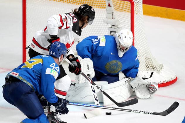 RIGA, LATVIA â€“ MAY 28, 2021: Kazakhstan s Darren Dietz (L), goaltender Andrei Shutov (R) and Canada s Max Comtois (C) in action in their 2021 IIHF Ice hockey, Eishockey World Championship, WM, Weltmeisterschaft Preliminary Round Group B match, at the Arena Riga. Natalia Fedosenko TASS  TS101EA3