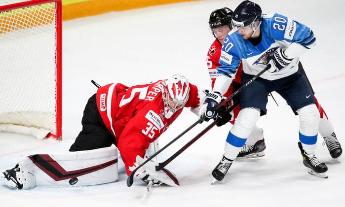 RIGA, LATVIA â€“ JUNE 1, 2021: Canada s goaltender Darcy Kuemper supported by Jacob-Bernard Docker defends against Finland s Niko Ojamaki (L-R) in their 2021 IIHF World Championship, WM, Weltmeisterschaft Group B Ice hockey, Eishockey match at Arena Riga. Natalia Fedosenko TASS  TS10257E