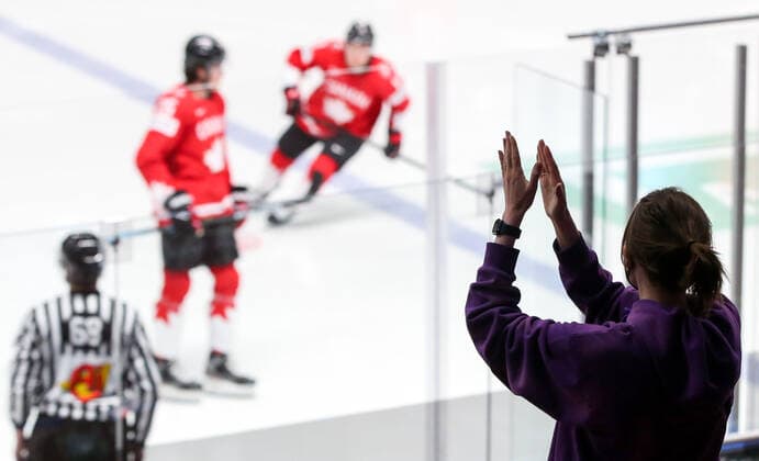 RIGA, LATVIA â€“ JUNE 1, 2021: A spectator applauds a 2021 IIHF World Championship, WM, Weltmeisterschaft Group B Ice hockey, Eishockey match between Canada and Finland at Arena Riga. Starting from June 1, those fans who were vaccinated against, or already recovered from, COVID-19 are allowed to attend IIHF World Championship matches in Latvia. Natalia Fedosenko TASS  TS102581