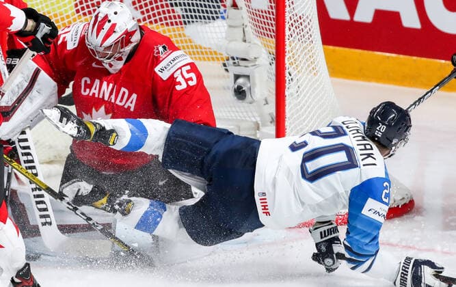 RIGA, LATVIA â€“ JUNE 1, 2021: Canada s goaltender Darcy Kuemper (L) defends against Finland s Niko Ojamaki in their 2021 IIHF World Championship, WM, Weltmeisterschaft Group B Ice hockey, Eishockey match at Arena Riga. Natalia Fedosenko TASS  TS102582