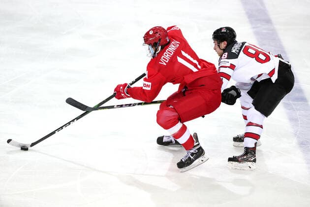 RIGA, LATVIA - JUNE 3, 2021: Russia s Dmitry Voronkov (L) and Canada s Andrew Mangiapane fight for the puck in their 2021 IIHF World Championship, WM, Weltmeisterschaft quarterfinal Ice hockey, Eishockey match at the Olympic Sports Center. Due to CAS sanctions, the Russian team performs under the name and flag of the Russian Olympic Committee (ROC). Natalia Fedosenko TASS  TS1032C0