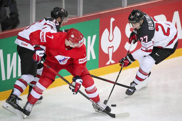 RIGA, LATVIA - JUNE 3, 2021: Canada s Justin Danforth, Russia s Dmitry Orlov, and Canada s Michael Bunting (L-R) in action in their 2021 IIHF World Championship, WM, Weltmeisterschaft quarterfinal Ice hockey, Eishockey match at the Olympic Sports Center. Due to CAS sanctions, the Russian team performs under the name and flag of the Russian Olympic Committee (ROC). Natalia Fedosenko TASS  TS103304