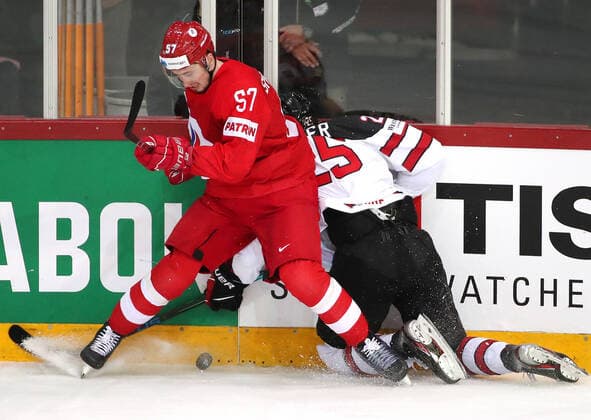 RIGA, LATVIA - JUNE 3, 2021: Russia s Artyom Shvets-Rogovoi (L) and Canada s Owen Power fight for the puck in their 2021 IIHF World Championship, WM, Weltmeisterschaft quarterfinal Ice hockey, Eishockey match at the Olympic Sports Center. Due to CAS sanctions, the Russian team performs under the name and flag of the Russian Olympic Committee (ROC). Natalia Fedosenko TASS  TS103339