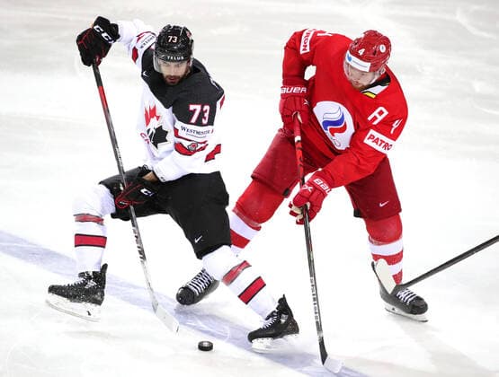 RIGA, LATVIA - JUNE 3, 2021: Canada s Brandon Pirri (L) and Russia s Vladislav Gavrikov fight for the puck in their 2021 IIHF World Championship, WM, Weltmeisterschaft quarterfinal Ice hockey, Eishockey match at the Olympic Sports Center. Due to CAS sanctions, the Russian team performs under the name and flag of the Russian Olympic Committee (ROC). Natalia Fedosenko TASS  TS1033A7