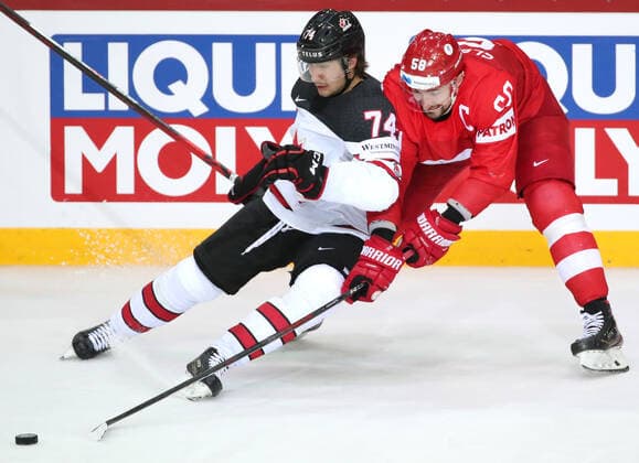 RIGA, LATVIA - JUNE 3, 2021: Canada s Nicolas Beaudin (L) and Russia s Anton Slepyshev fight for the puck in their 2021 IIHF World Championship, WM, Weltmeisterschaft quarterfinal Ice hockey, Eishockey match at the Olympic Sports Center. Due to CAS sanctions, the Russian team performs under the name and flag of the Russian Olympic Committee (ROC). Natalia Fedosenko TASS  TS1033AA