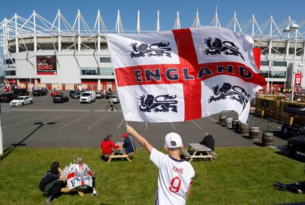 Middlesbrough, England, 6th June 2021. A young fan flies the flag outside the stadium during the International Friendly, Länderspiel, Nationalmannschaft match at the Riverside Stadium, Middlesbrough. Picture credit should read: Darren Staples Sportimage EDITORIAL USE ONLY. No use with unauthorised audio, video, data, fixture lists, club league logos or live services. Online in-match use limited to 120 images, no video emulation. No use in betting, games or single club league player publications. SPI-1079-0007