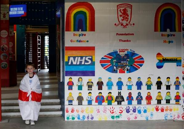 Middlesbrough, England, 6th June 2021. A young fan walks past a wall mural before the International Friendly, Länderspiel, Nationalmannschaft match at the Riverside Stadium, Middlesbrough. Picture credit should read: Darren Staples Sportimage EDITORIAL USE ONLY. No use with unauthorised audio, video, data, fixture lists, club league logos or live services. Online in-match use limited to 120 images, no video emulation. No use in betting, games or single club league player publications. SPI-1079-0020